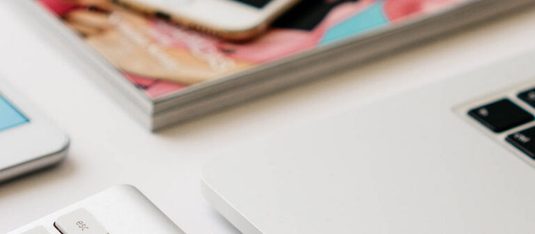 laptop and magazines on a desk