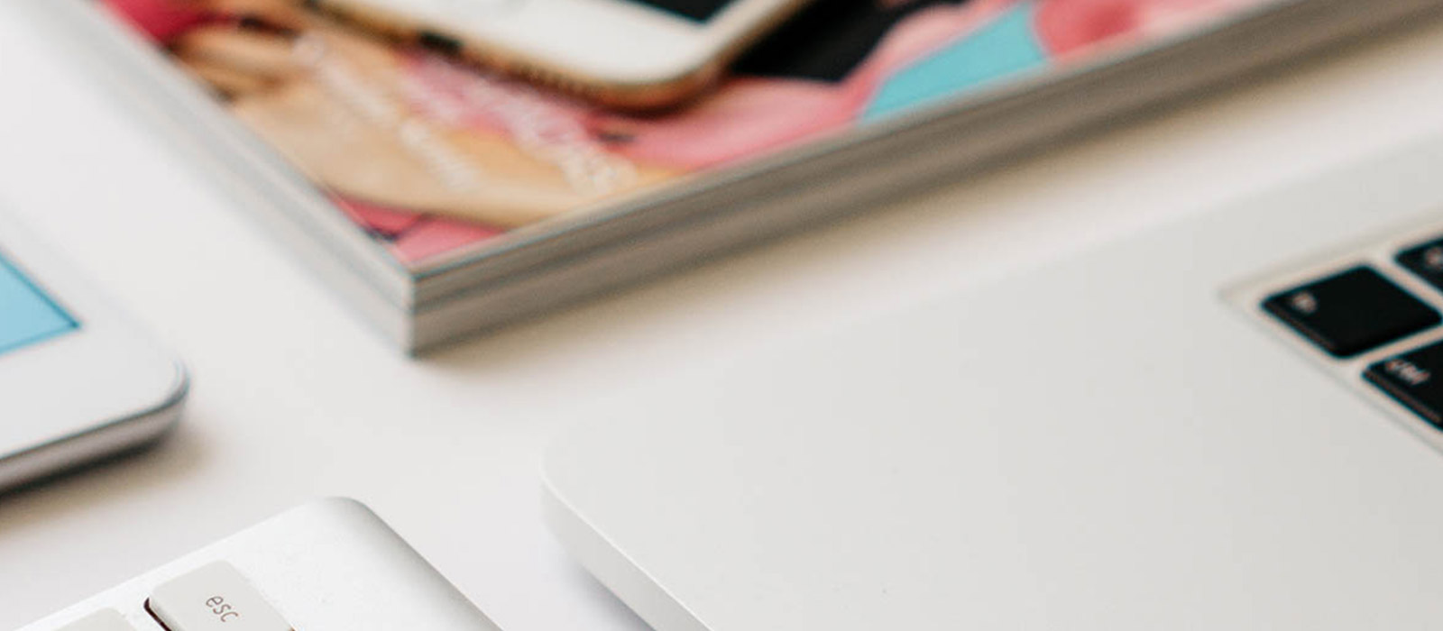 laptop and magazines on a desk