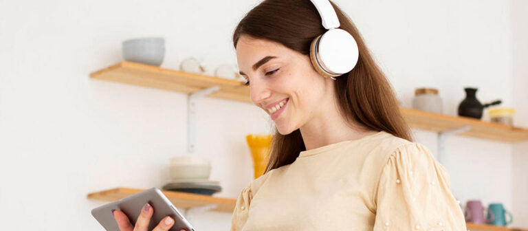 a woman listening to music on her headphones and smiling