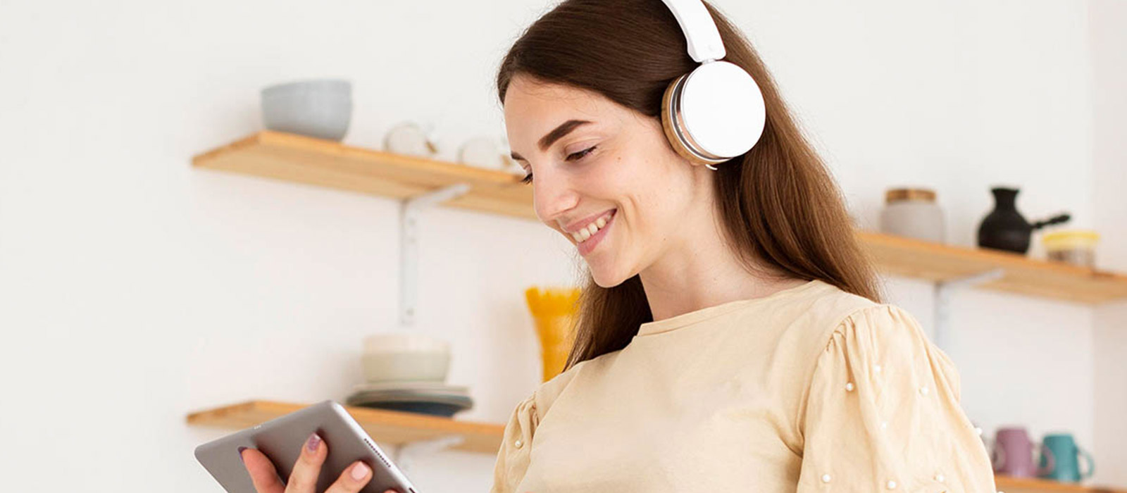 a woman listening to music on her headphones and smiling