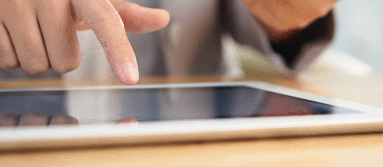 a person clicking on an ipad