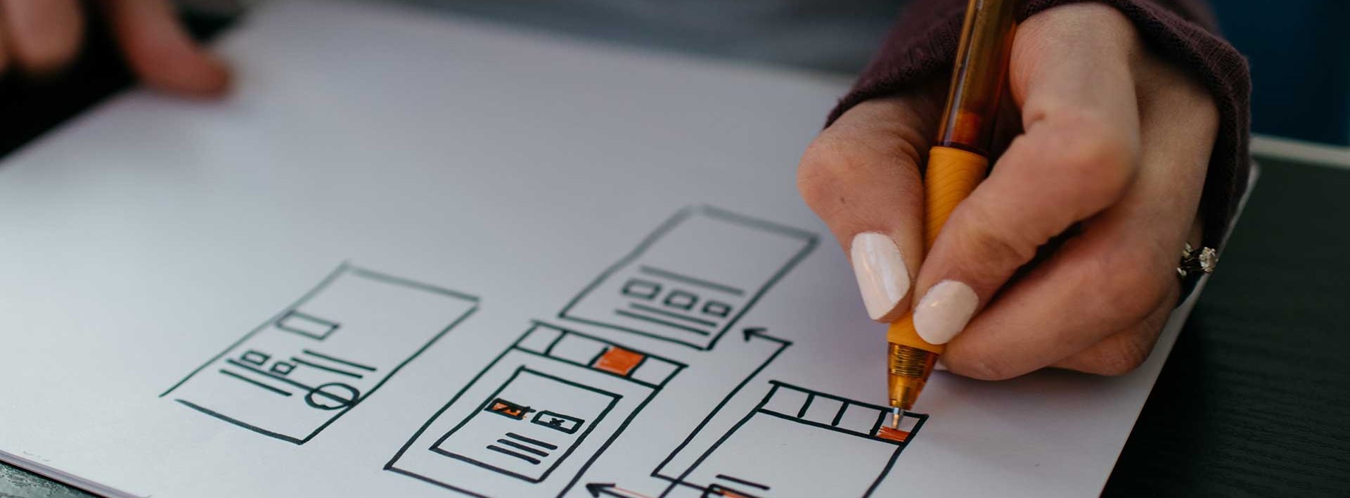 person drawing on a piece of paper