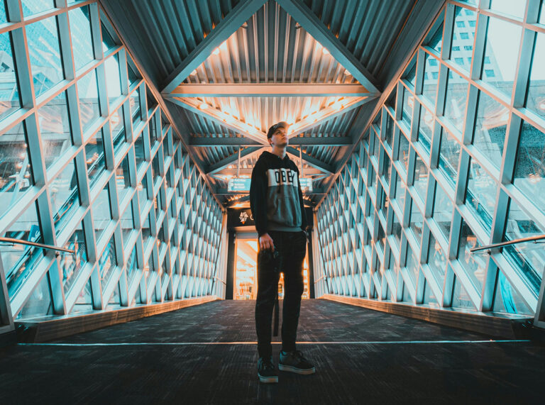 person standing in between two blue walls