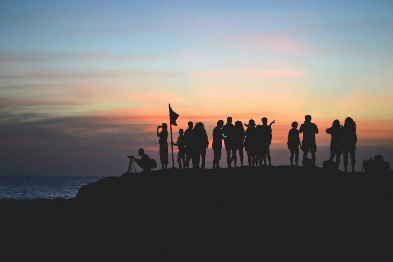 people on a mountain with an evening skyline