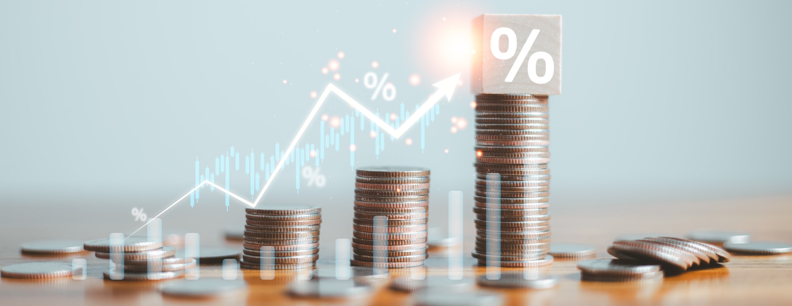 coins stacked on a table from a few to more and an increase in percentage shown