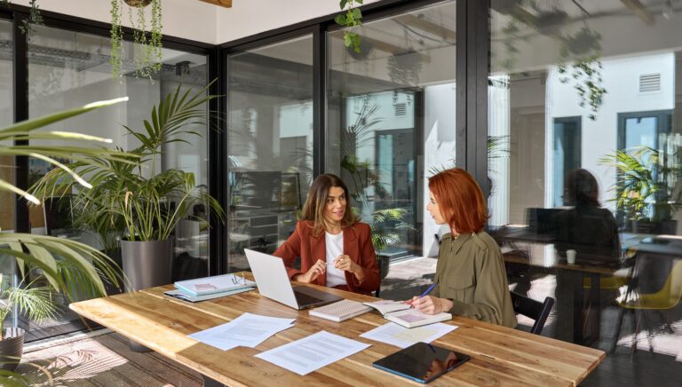 two women in a meeting room