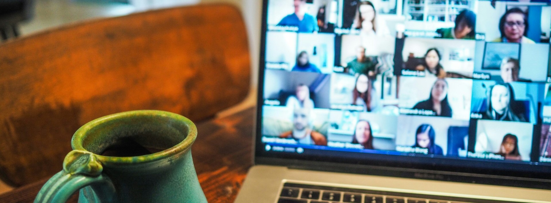a conference call on a laptop with a cup of tea