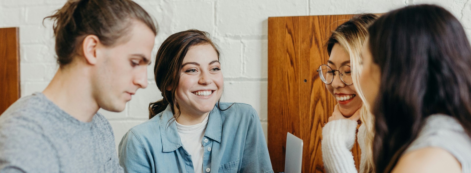 a group of people talking and smiling