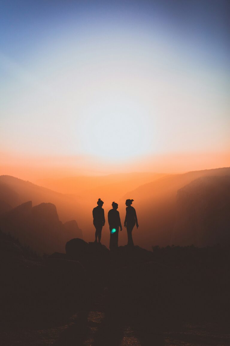 three people outside during sunrise