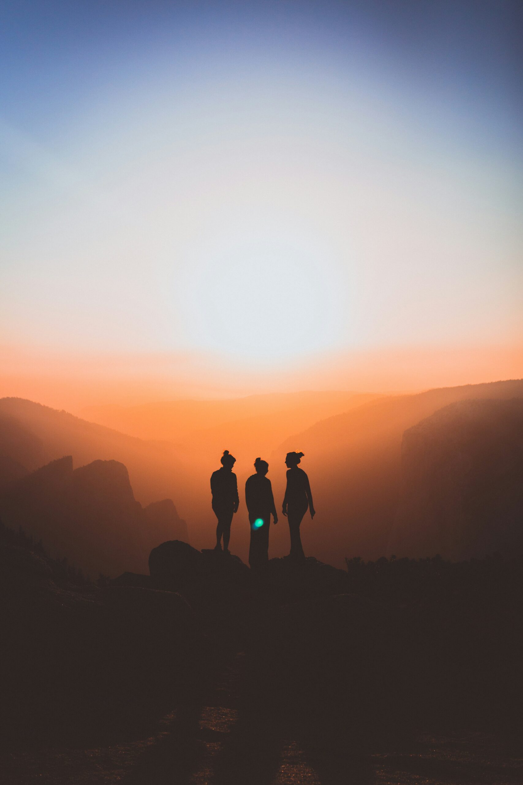 three people outside during sunrise