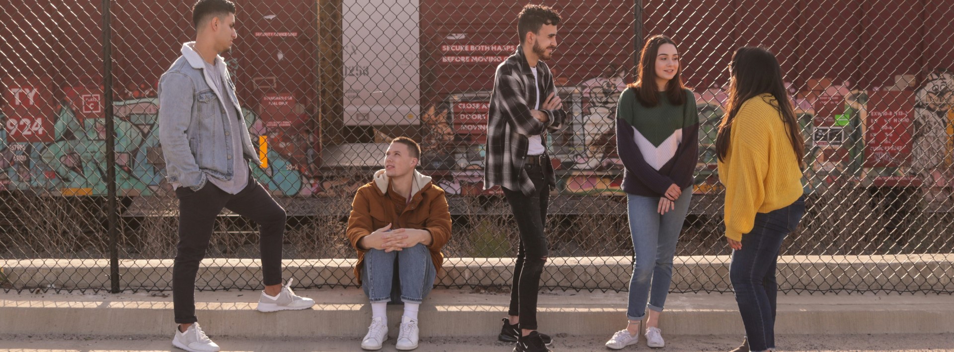 a group young people standing in the street