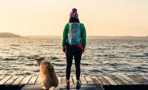 woman with a dog looking at water