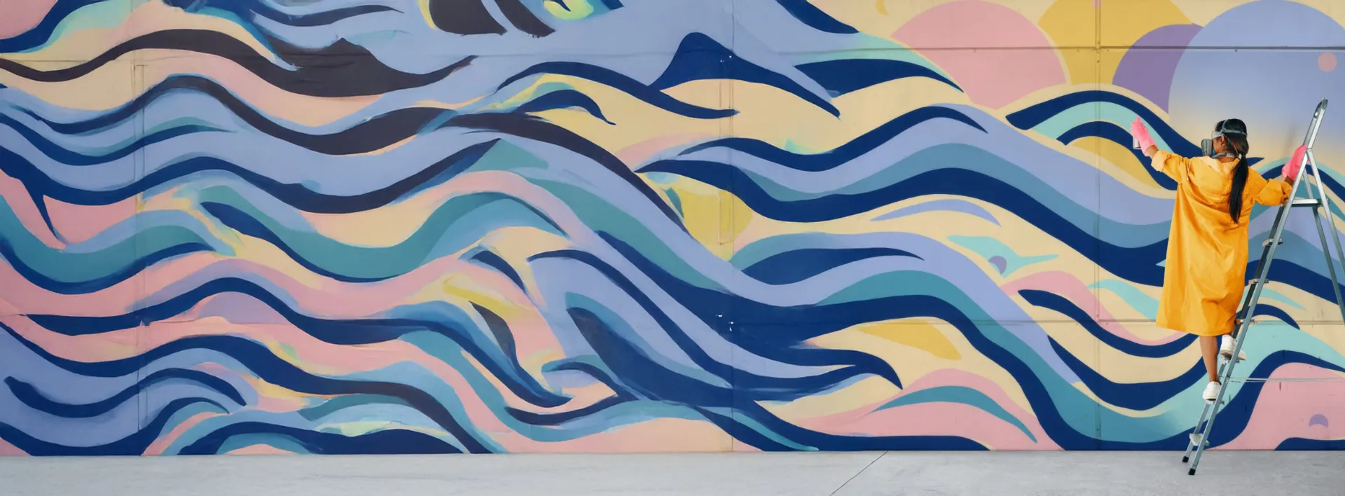 a woman painting a colourful wall