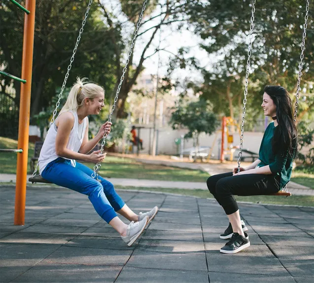 two women on swings