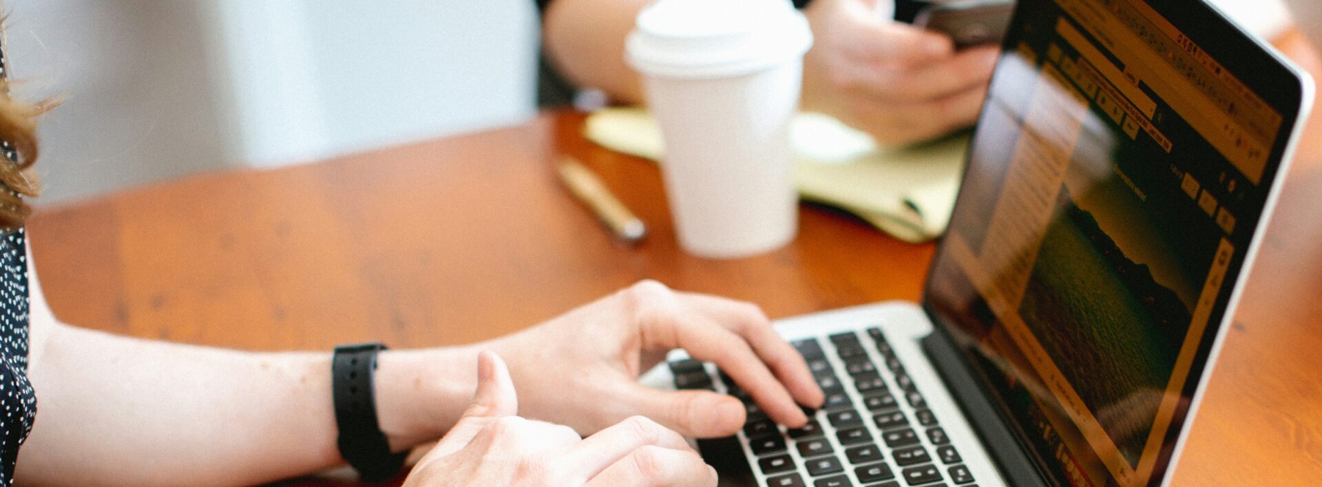 hands on a laptop's keyboard