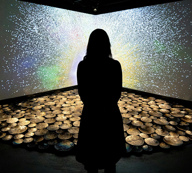 silhouette of a person stood in front of light