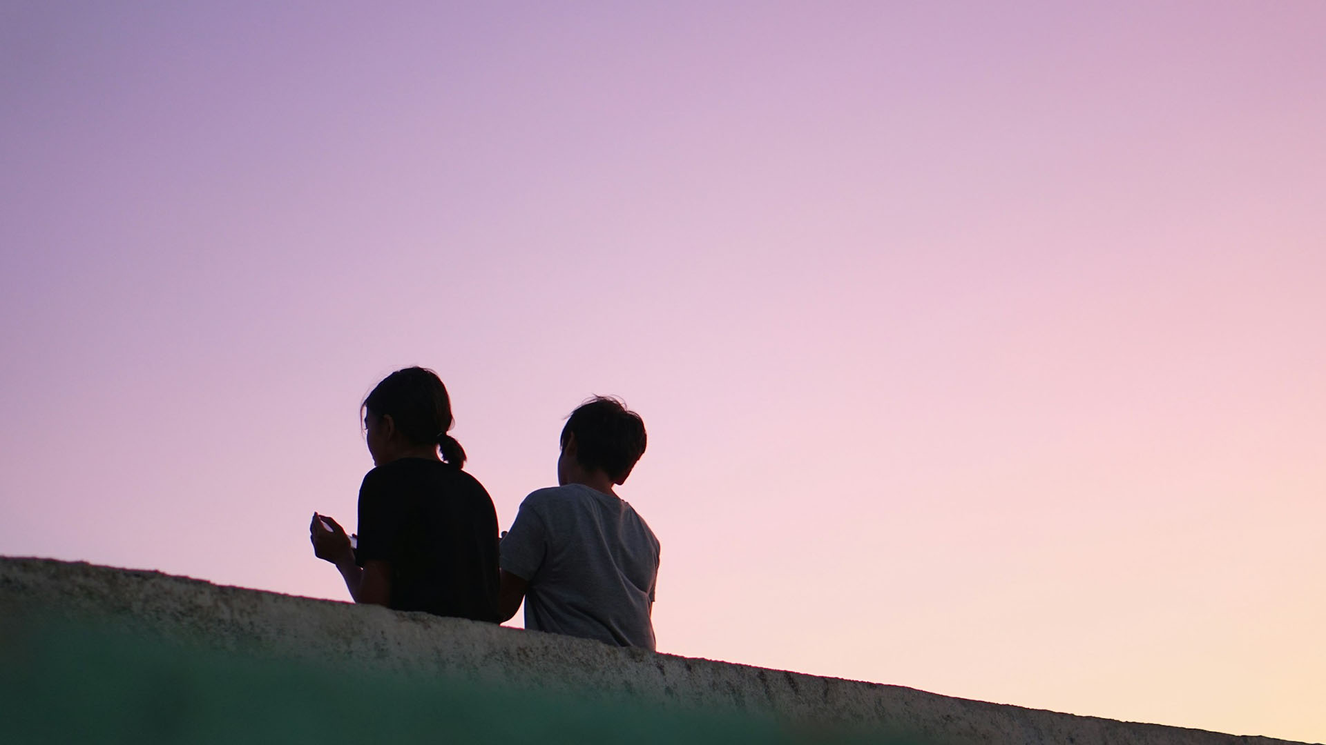 two people in purple sky background