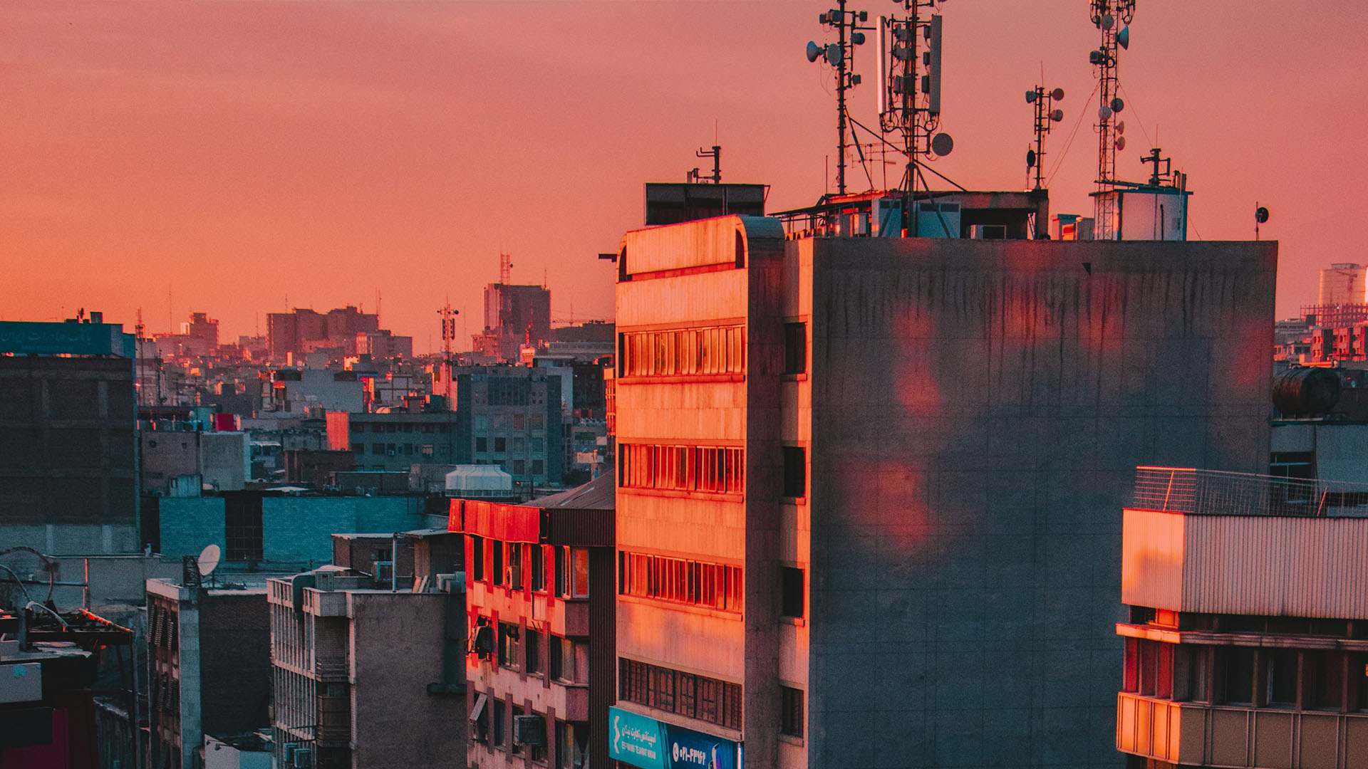 City skyline at sunset with buildings.