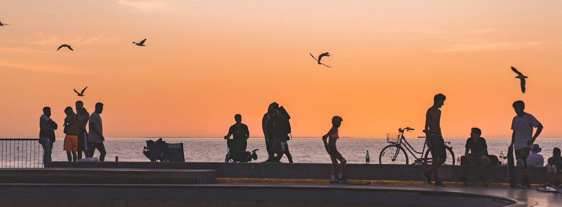 Silhouettes at sunset by the sea.