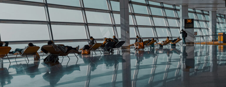 Row of seating facing the windows inside an airport.