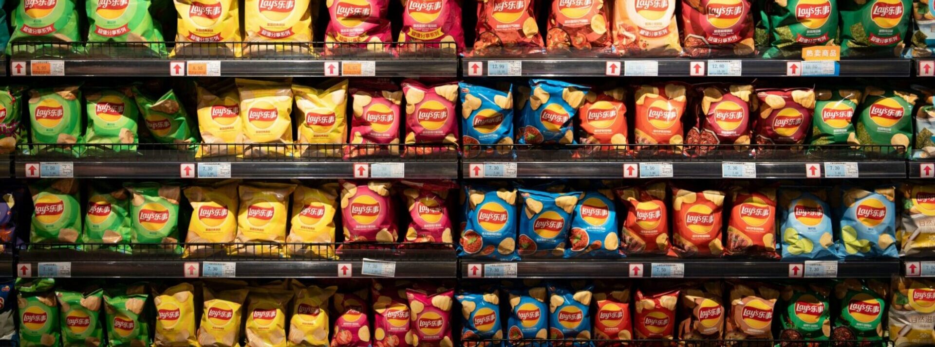 Close up of store shelving showing Walkers crisps