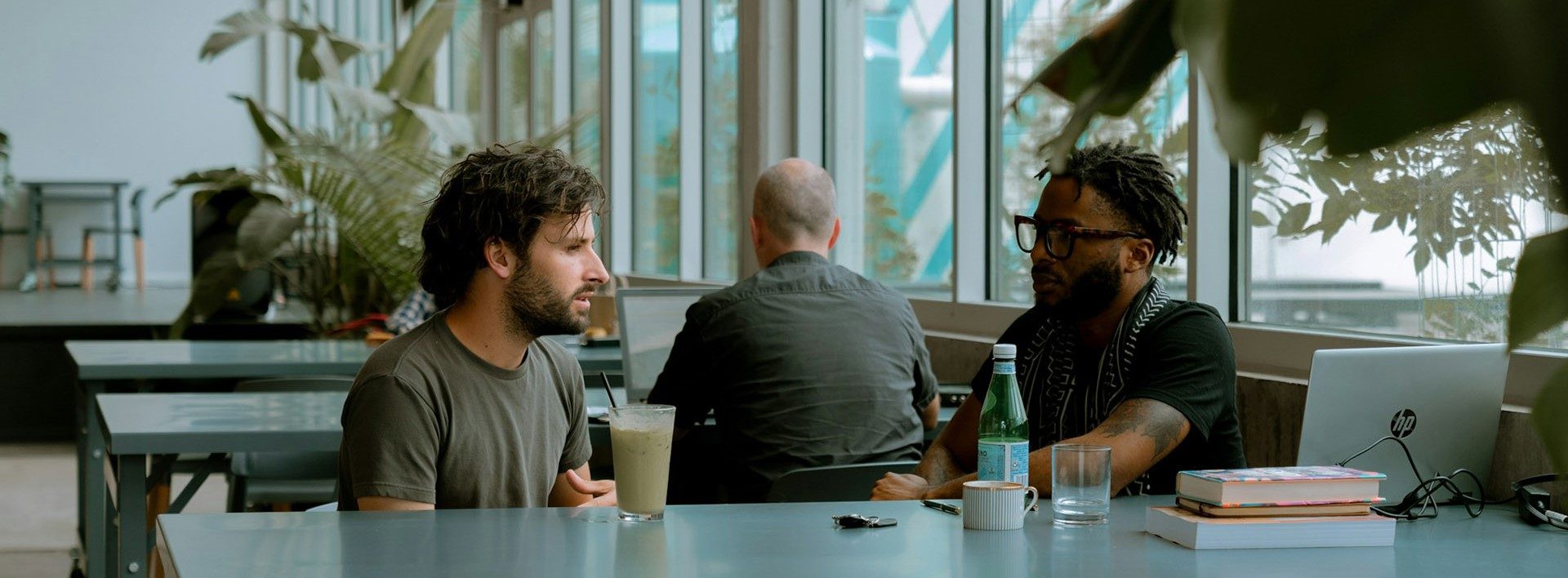 Two people conversing in a café.